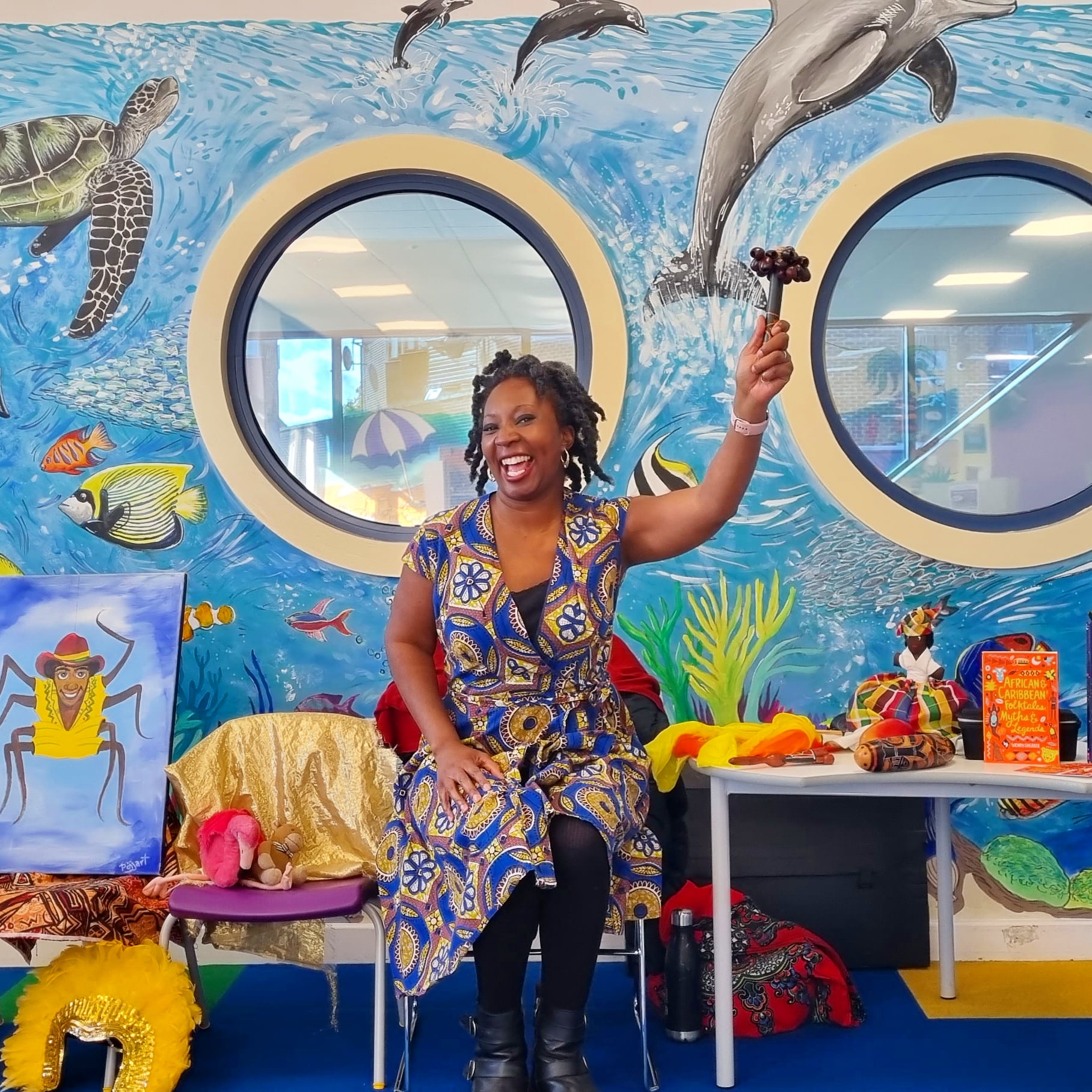 Wendy Shearer infront of a library mural of sea creatures