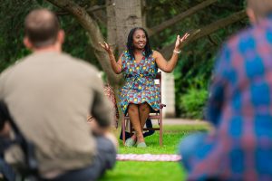 Wendy Shearer storytelling under a tree - photographer Ross Kernahan