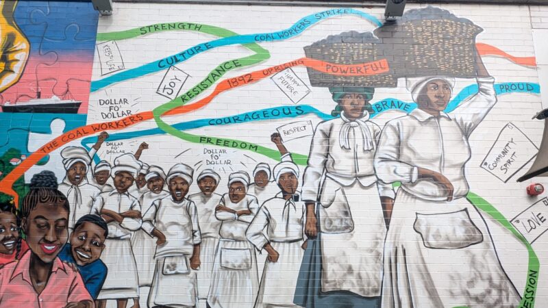 Mural of black coal workers at the Postal Museum